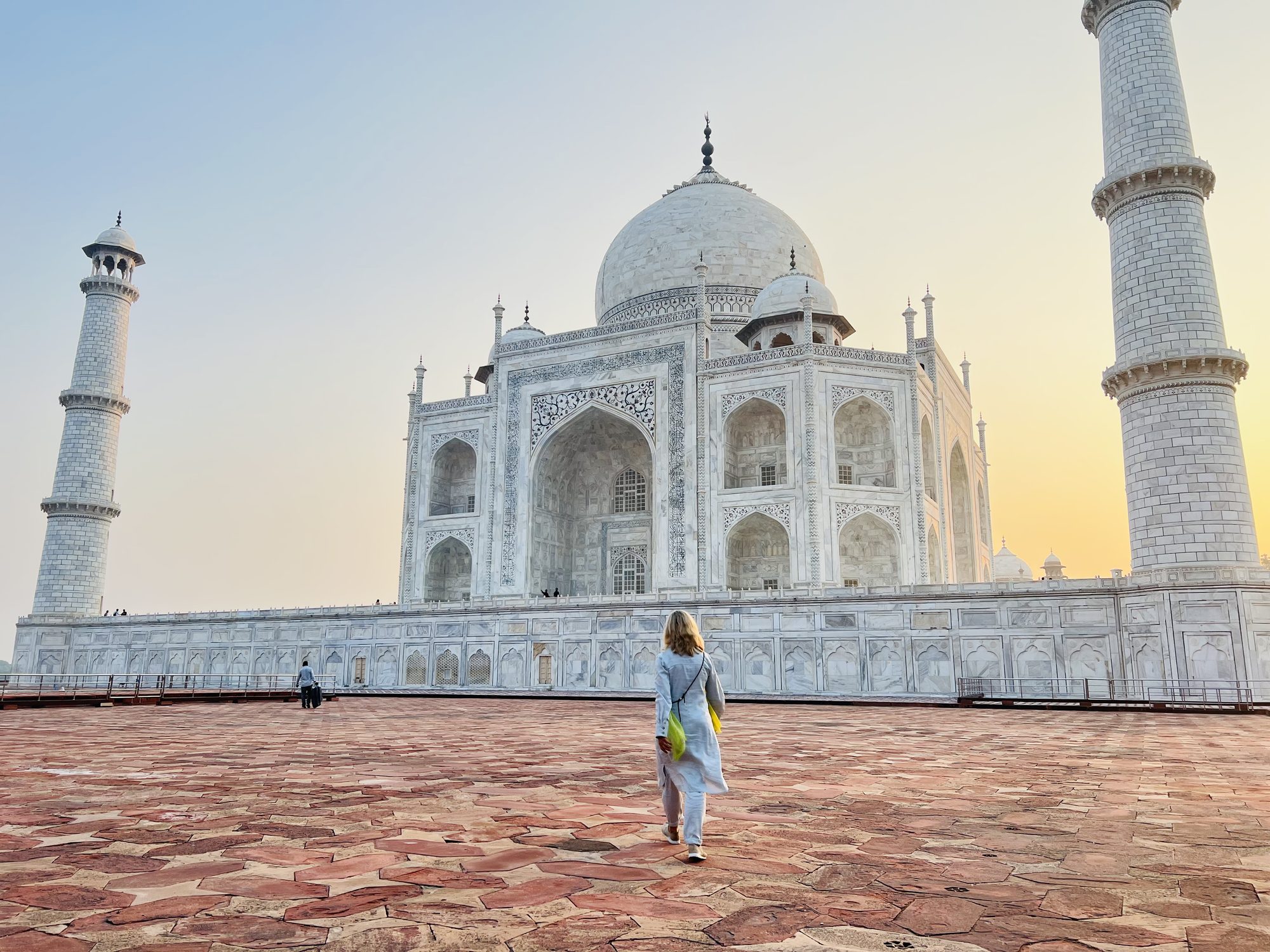 Susi Rose walking across the marble terrace toward the Taj Mahal at sunrise